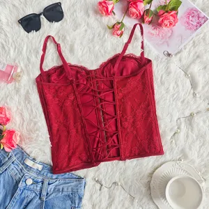 Red lace corset detail, strappy backless bustier top, chic intimate apparel close up.