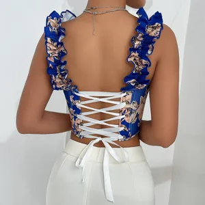 Close-up back detail of blue floral corset top with white lace-up straps and ruffles.