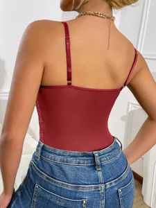 Detailed view of red lace spliced backless bodysuit paired with blue denim jeans and necklace.