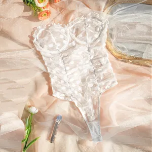 Detailed close-up shot featuring a gorgeous white sheer polka dot ruffled mesh lingerie bodysuit.