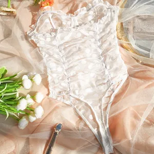 Detailed view of white mesh lace bodysuit featuring delicate ruffles and underwire support.