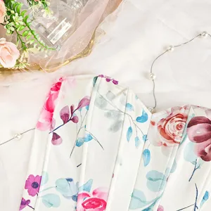 Detail view of floral print corset top with structured boning seams and sweet sweetheart neckline.