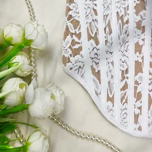 Detail shot of white lace strapless bustier top showing delicate floral pattern and boning.