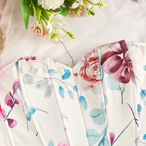 Close-up detail of floral print corset crop top, showing structured boning and fabric texture.