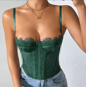 Close-up of green lace trim boned corset top with sheer mesh and delicate straps detail.