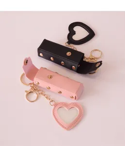 Draagbare PU lederen lippenstift houder met hart make-up spiegel sleutelhanger detail.