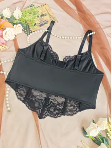 Black lace bustier camisole top with adjustable straps and floral hem detail for women.
