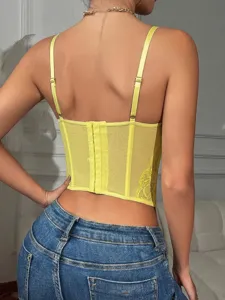 Detail view of a stunning yellow lace corset top featuring adjustable straps and chic design.