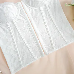 Detailed view of the white lace corset top, highlighting the delicate fabric and boning structure.