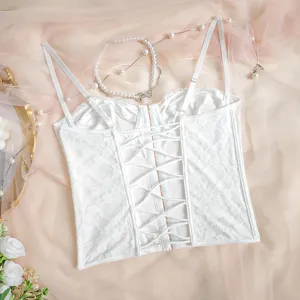 Detailed view of a white lace corset top featuring delicate floral patterns and back lacing.