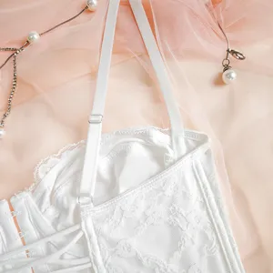 White lace bustier top featuring adjustable straps and delicate floral lace detailing.