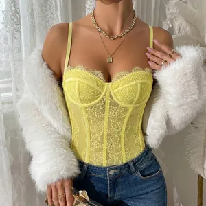 Yellow lace bodysuit detail view, sheer mesh design with fluffy white jacket and denim jeans.