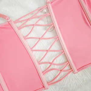 Pink backless camisole top detail view, featuring elegant lace-up criss-cross back straps.