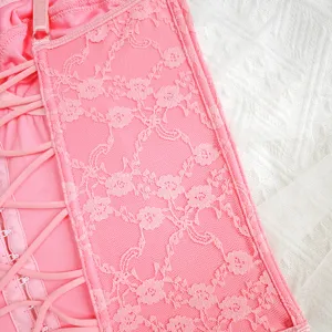 Pink lace corset top detail, floral embroidery texture, backless strap camisole design for women.