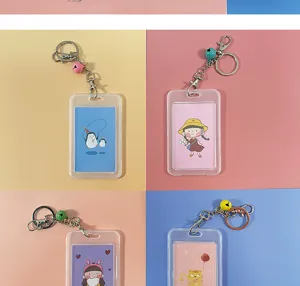 Clear transparent card holder detail with cute cartoon inserts and metal keychain attachment.