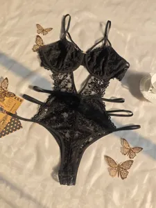 Detailed close-up view of black lace sexy bodysuit featuring underwire and strappy cutouts.