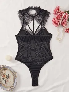 Black lace sheer mesh bodysuit featuring chic halter neck, backless design and delicate lace trim.