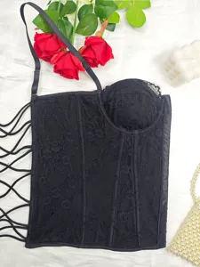Black lace bustier top detail view showcasing the intricate floral pattern and stylish design.