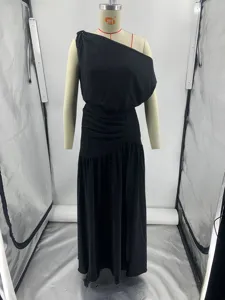 Detail view of a black one shoulder maxi dress, off shoulder design with waist slit for summer.