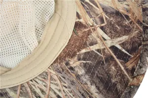 Close-up detail showing the inner breathable mesh lining and stitching of the camo hat.