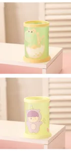 Cute cartoon pen holder detail view, green cylindrical stationery organizer for office and desk.