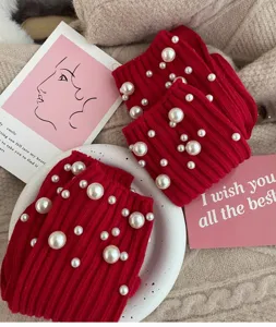 Red pearl knit socks detail shot showing festive winter hosiery with elegant pearl embellishments.