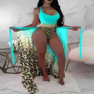 Women turquoise leopard print one piece swimsuit with matching beach sarong wrap.