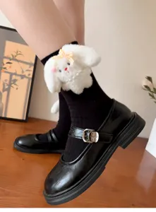 Black Mary Jane shoes paired with cute plush rabbit crew socks, detailed close-up shot.