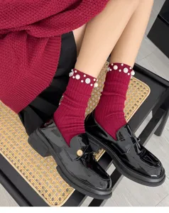 Detailed shot of anchor red mid-tube socks with elegant pearl and rhinestone beading.