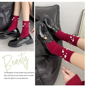 Detail view of women autumn winter pearl mid calf socks with elegant beads and leather shoes.