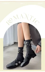 Detail shot of women autumn winter pearl knit socks, ribbed mid tube socks with elegant beads.