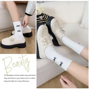 Sweet plaid bow pearl white mid-calf socks paired with retro platform loafers for women.