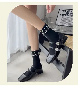 Close-up of black pearl rhinestone socks paired with patent Mary Jane shoes for daily wear.