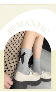 Grey ribbed mid-calf socks featuring black bow and pearl details, perfect for cute sweet style.