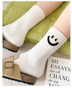Korean style white ribbed mid-tube socks featuring a glitter rhinestone winking smiley face design.