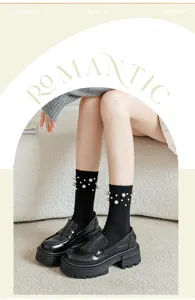 Pearl embellished black rib knit socks paired with trendy platform loafers in close-up view.