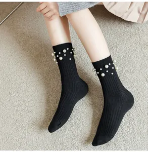 Black ribbed crew socks with chic pearl embellishments, cozy soft cotton fashion hosiery.