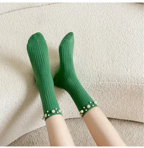 Green ribbed crew socks for women featuring elegant pearl and rhinestone beaded cuffs.