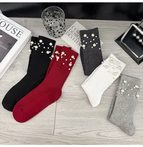Close-up of trendy women's ribbed knit socks featuring delicate faux pearl embellishments.