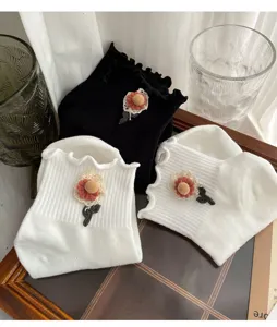 Sweet daisy ruffle socks for women, cute white and black crew socks for daily wear.