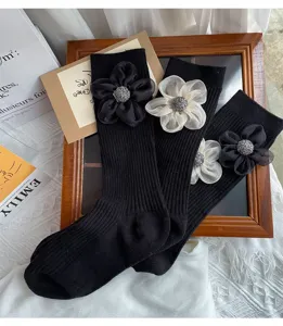 Black mid-calf socks for women featuring 3D floral applique and rhinestone embellishments.