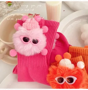 Cute girls mid-tube socks featuring fluffy plush elf doll, knit hat and stylish glasses.