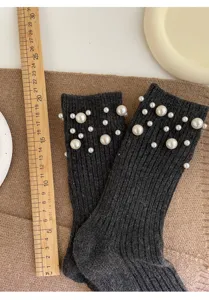 Detailed view of dark grey pearl embellished mid-calf socks, featuring cozy knit style for women.