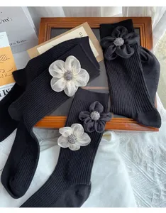 Black mid-calf socks for women featuring elegant 3D organza flower and rhinestone design.