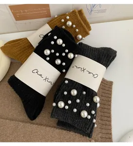 Close-up detail of warm winter knit crew socks adorned with elegant artificial pearls.