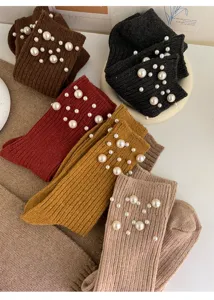 Detail view of knitted mid-calf slouch socks featuring elegant pearl beading for autumn and winter.