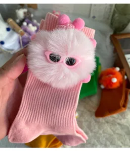 Cute fuzzy doll mid-calf socks for women, playful pink knit hosiery with plush pom-pom detail.