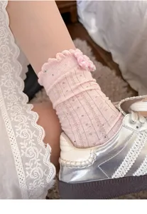 Pink ruffled mid-tube socks with sweet plaid bow, soft cotton fabric, close-up detail shot.