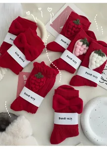 Cute red cotton mid-tube socks with 3D strawberry and bow detail, cozy winter festive style.