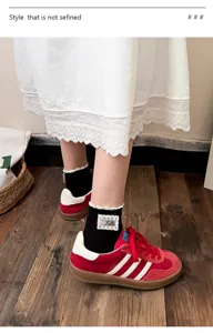 Close-up detail of Japanese style ruffle lace short socks paired with retro sneakers.